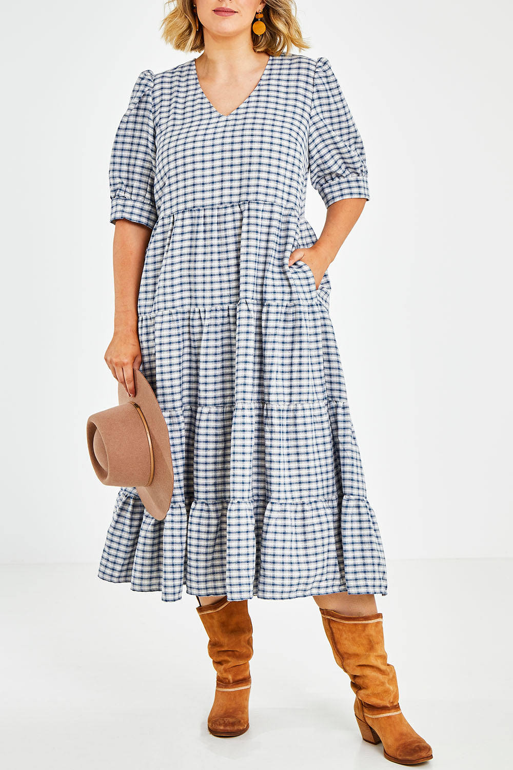 Model Jess wearing size 14 of the Tiers Of Delight Dress in colour Bluecheck (Blue), from the front, cropped image