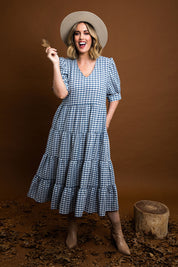 Model Jess wearing size 14 of the Tiers Of Delight Dress in colour Bluecheck (Blue), from the front, showing the whole outfit