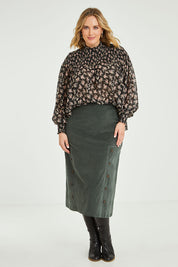 Model Jess wearing size 14 of the Smooth Lines Stretch Cord Skirt in colour Khaki (Green), from the front, showing the whole outfit