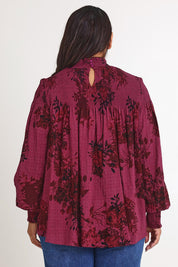 Model Ashleigh wearing size 16 of the Romance In The Air Blouse in colour Shiraz (Purple), from the back