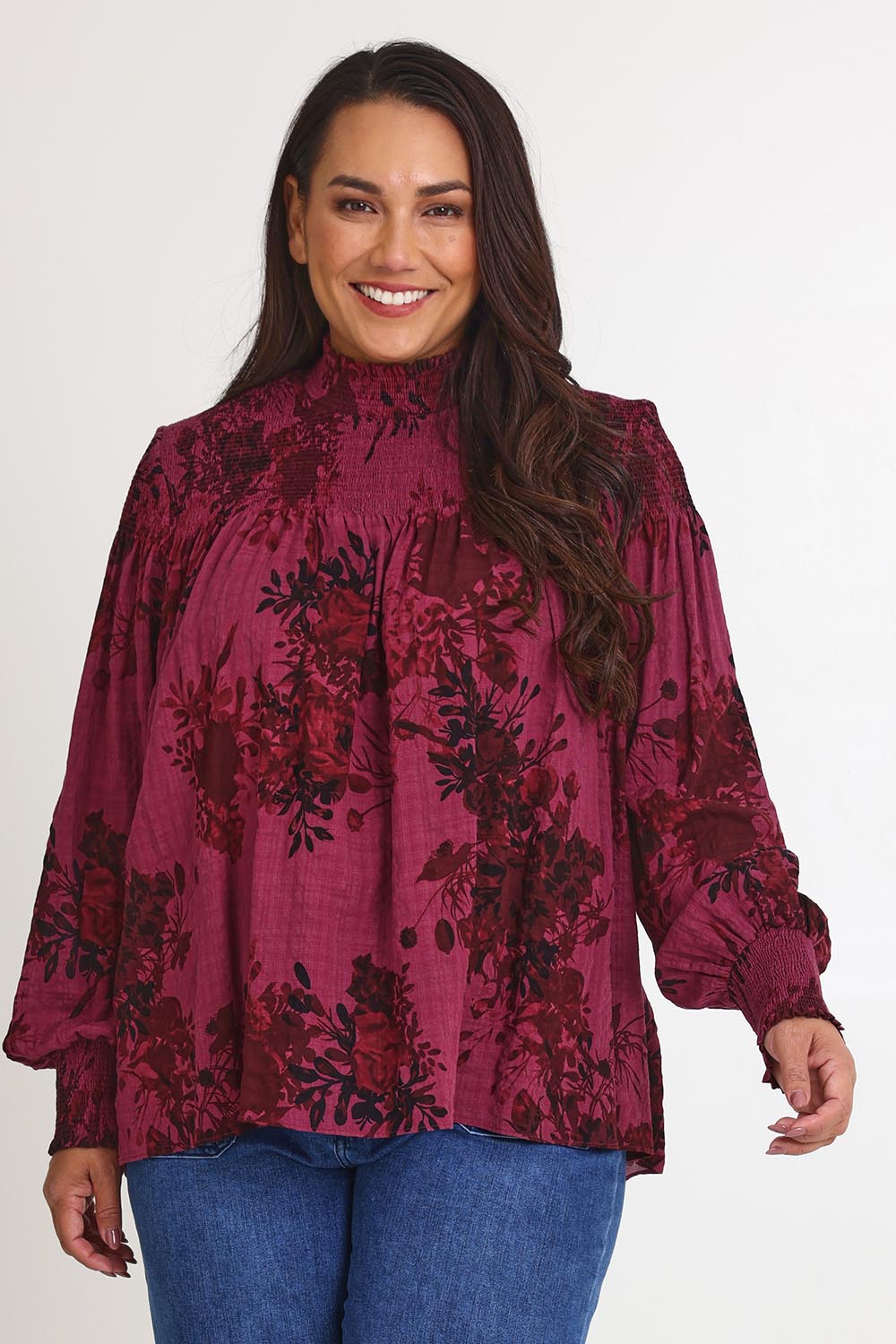 Model Ashleigh wearing size 16 of the Romance In The Air Blouse in colour Shiraz (Purple), from the front, cropped image
