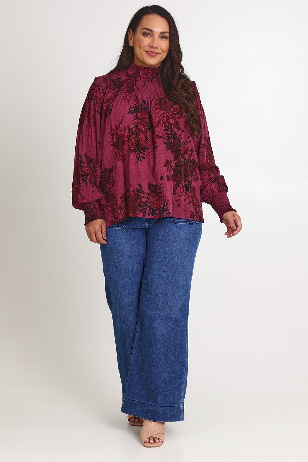 Model Ashleigh wearing size 16 of the Romance In The Air Blouse in colour Shiraz (Purple), from the front, showing the whole outfit