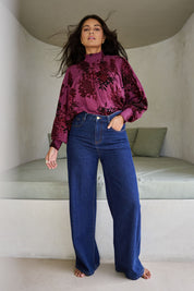 Model Tahnee wearing size 10 of the Romance In The Air Blouse in colour Shiraz (Purple), from the front, showing the whole outfit