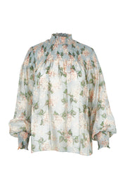 Product shot of the Romance In The Air Blouse in colour Skyfleur (Blue), from the front