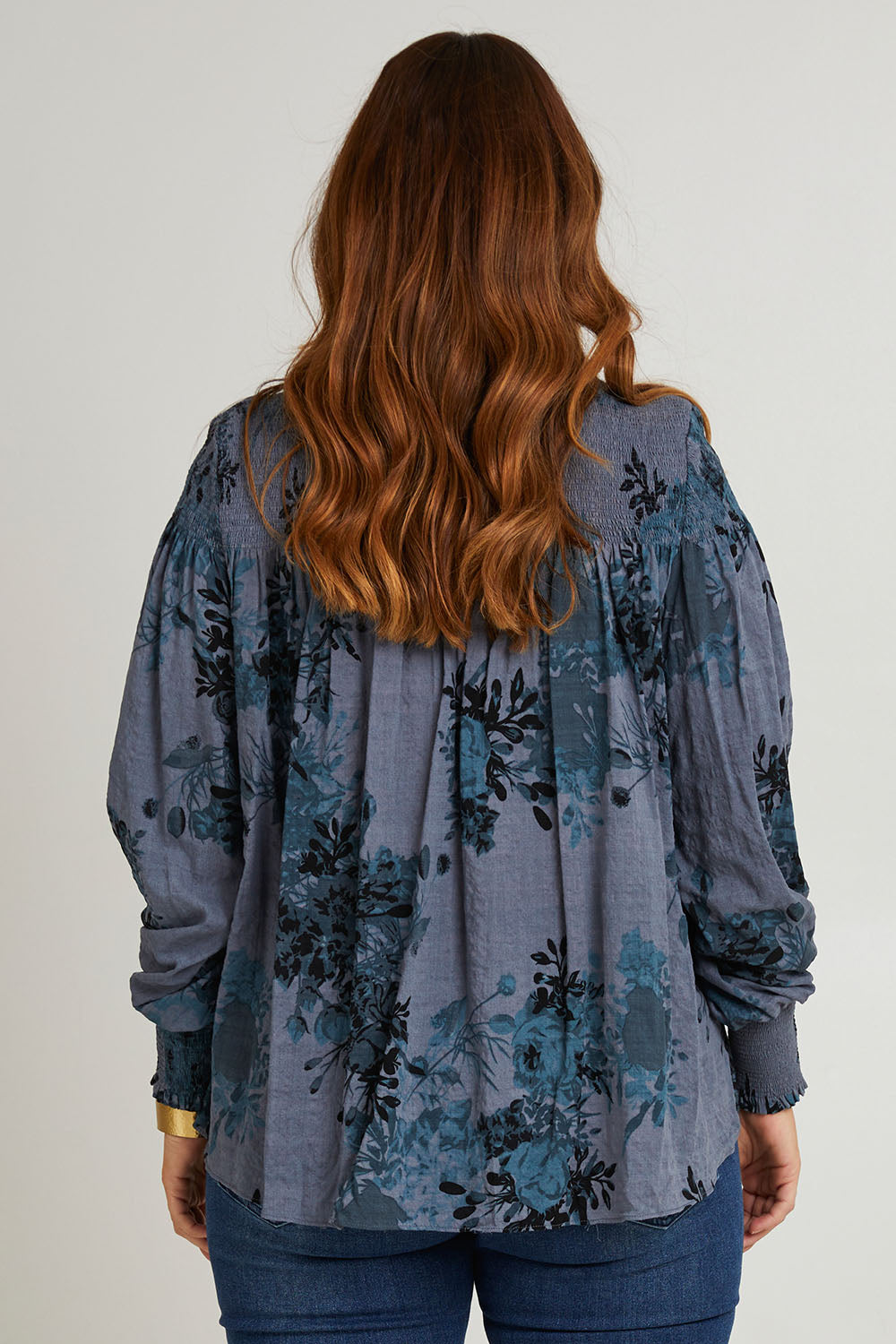 Model Laura wearing size 14 of the Romance In The Air Blouse in colour Smoke (Grey), from the back