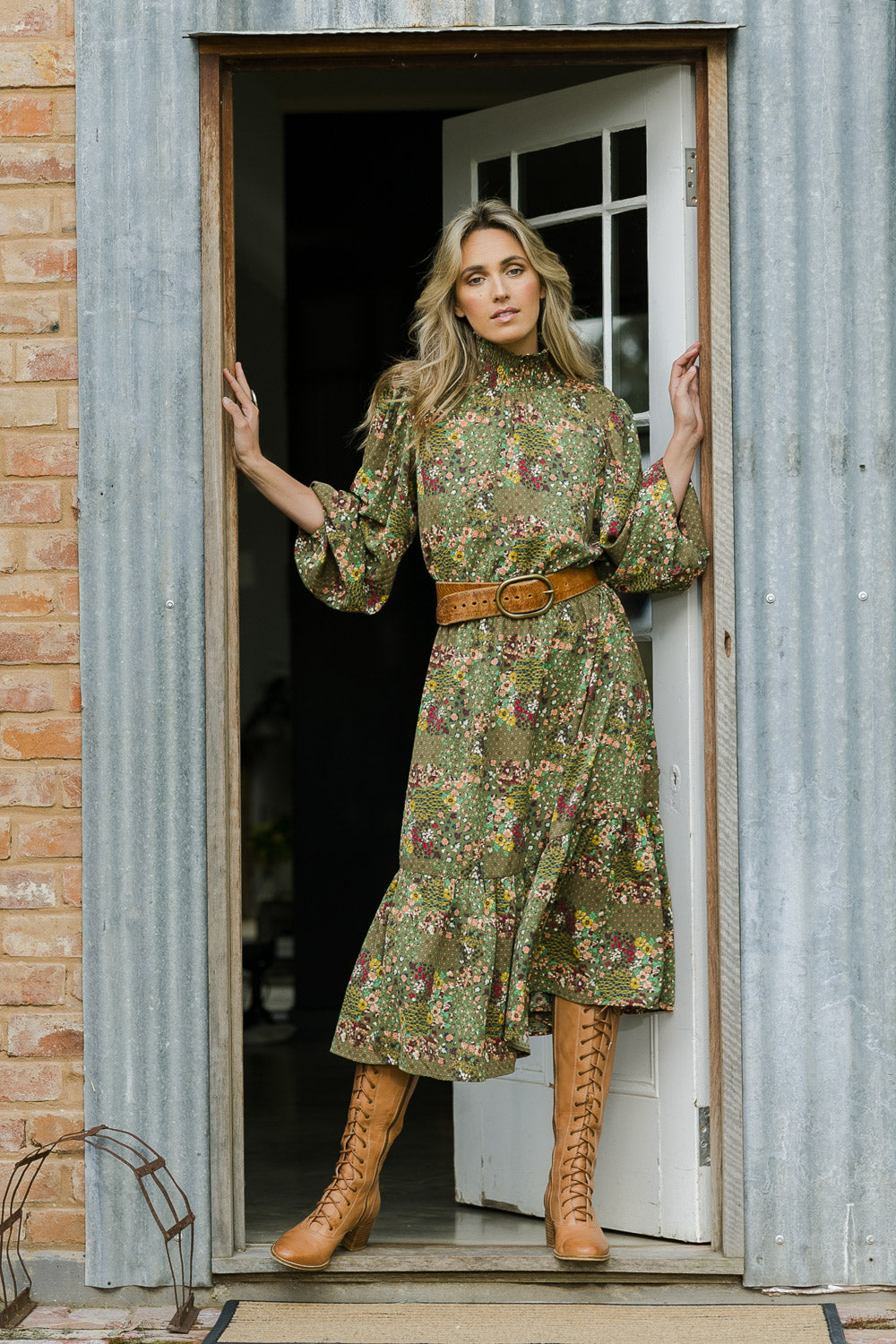 Model Tegan wearing size 10 of the Teatime And Flowers Dress in colour Forest (Green), from the front, showing the whole outfit