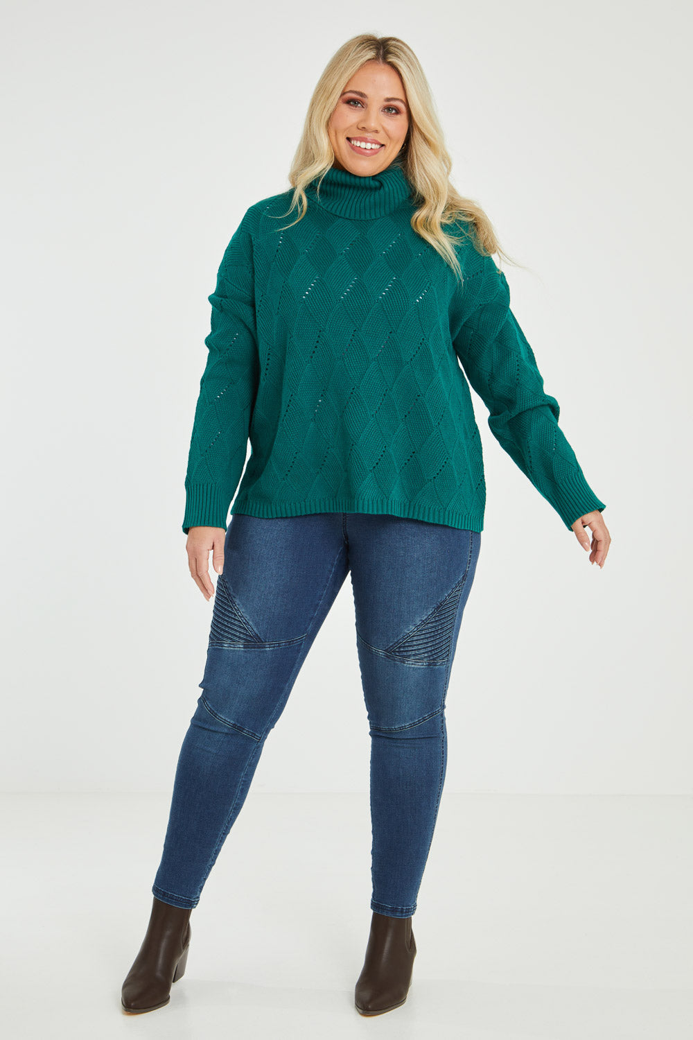 Model Katie wearing size XL of the Cross My Heart Stitch Sweater in colour Jade (Green), from the front, showing the whole outfit