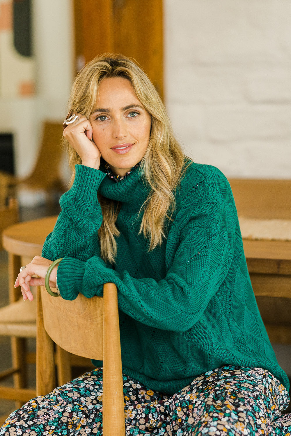 Model Tegan wearing size S of the Cross My Heart Stitch Sweater in colour Jade (Green), from the front, showing the whole outfit