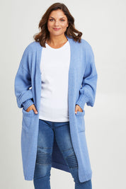 Model Monique wearing size L of the A True Jewel Cardi in colour Sky (Blue), from the back