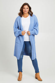 Model Monique wearing size L of the A True Jewel Cardi in colour Sky (Blue), from the front, showing the whole outfit