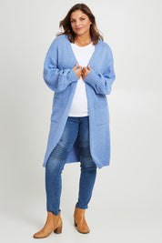 Model Monique wearing size L of the A True Jewel Cardi in colour Sky (Blue), from the front, showing the whole outfit