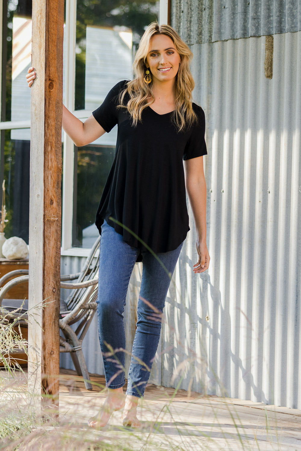 Model Tegan wearing size 10 of the Softly Swinging Bamboo Tee in colour Black (Black), from the front, showing the whole outfit