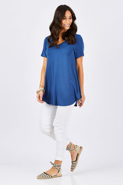 Model Georgia wearing size 10 of the Softly Swinging Bamboo Tee in colour BlueJeans (Blue), from the front, showing the whole outfit