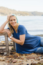 Model Phoebe wearing size 10 of the Softly Swinging Bamboo Tee in colour BlueJeans (Blue), from the front, showing the whole outfit