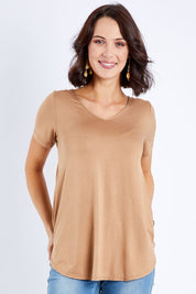 Model Andrea wearing size 10 of the Softly Swinging Bamboo Tee in colour Camel, from the front, cropped image