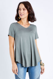 Model Andrea wearing size 10 of the Softly Swinging Bamboo Tee in colour Fern (Green), from the front, cropped image