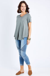 Model Andrea wearing size 10 of the Softly Swinging Bamboo Tee in colour Fern (Green), from the front, showing the whole outfit