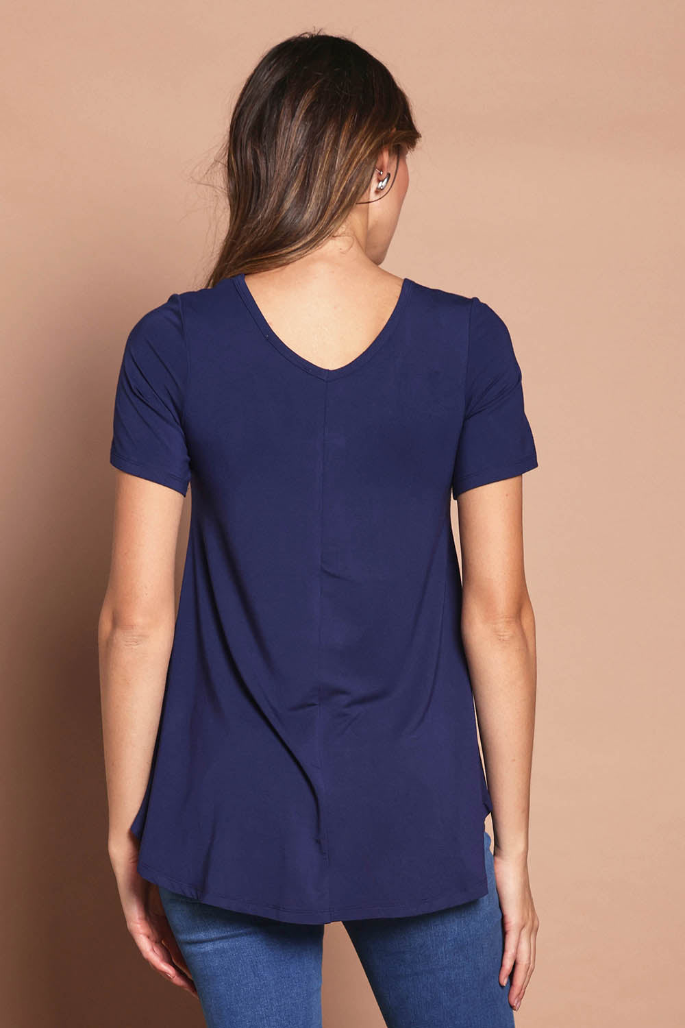 Model Madeline wearing size 10 of the Softly Swinging Bamboo Tee in colour Navy (Blue), from the back
