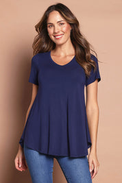 Model Madeline wearing size 10 of the Softly Swinging Bamboo Tee in colour Navy (Blue), from the front, cropped image