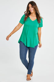 Model Laura wearing size 14 of the Softly Swinging Bamboo Tee in colour Verde (Green), from the front, showing the whole outfit