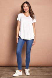 Model Madeline wearing size 10 of the Softly Swinging Bamboo Tee in colour White (White), from the front, showing the whole outfit