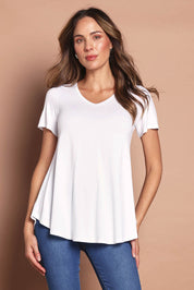 Model Madeline wearing size 12 of the Softly Swinging Bamboo Tee in colour White (White), from the front, cropped image