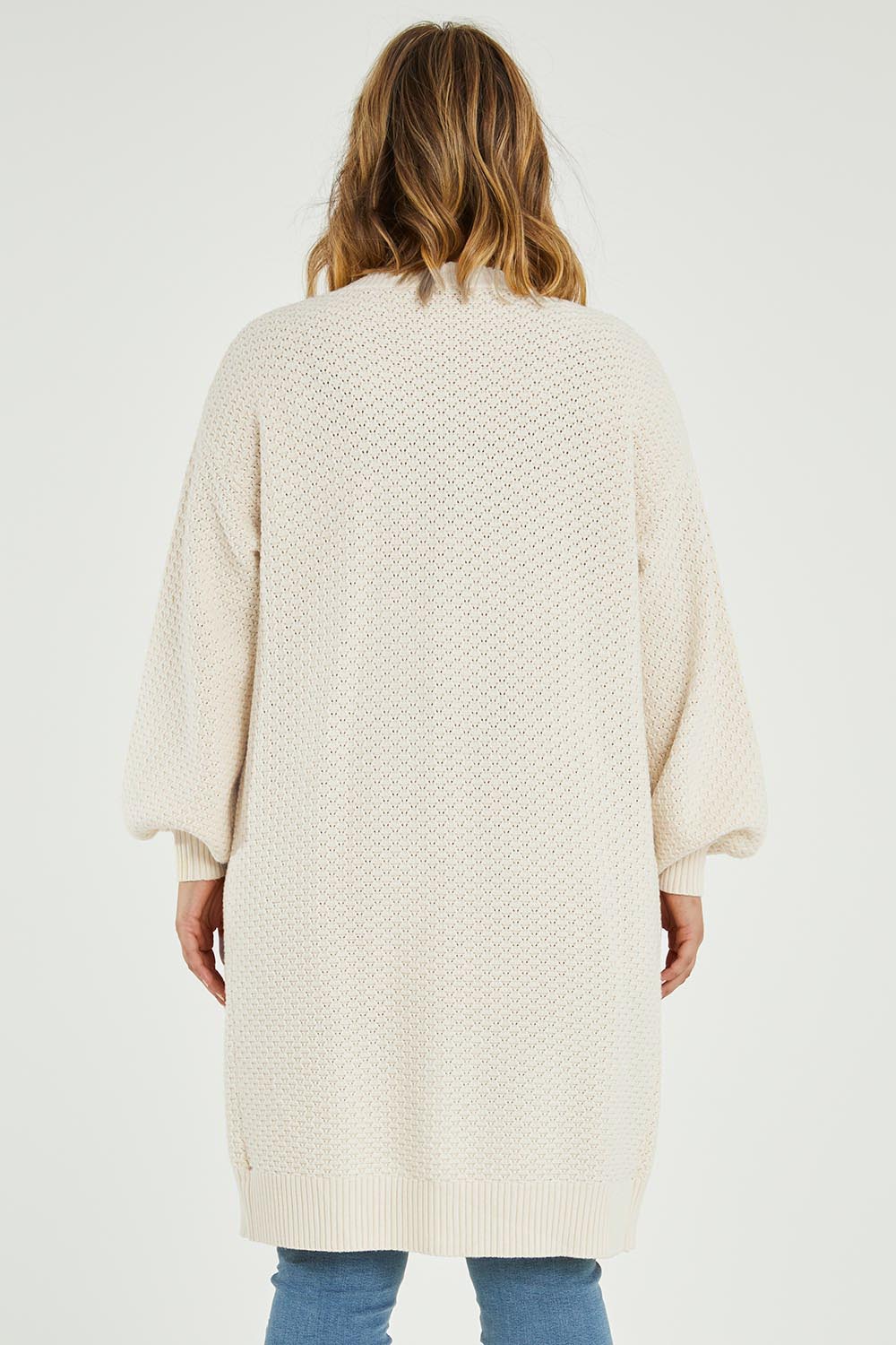 Model Jess wearing size L of the Adjourn To The Drawing Room Cardi in colour Buttermilk, from the back