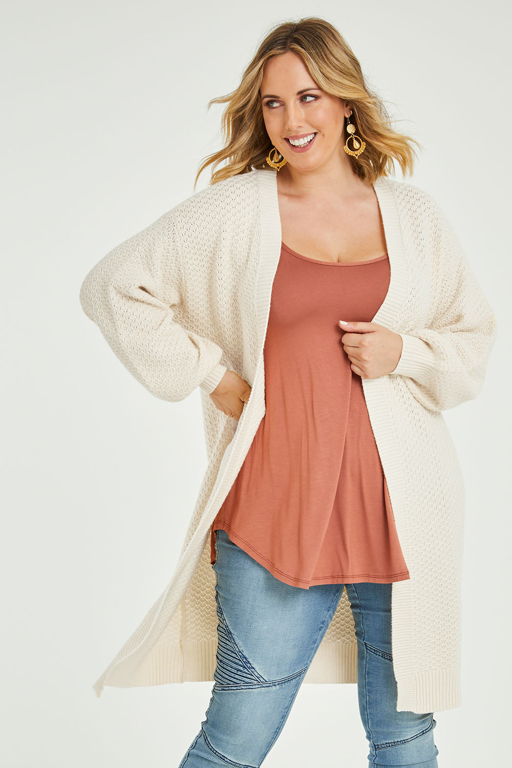 Model Jess wearing size L of the Adjourn To The Drawing Room Cardi in colour Buttermilk, from the front, cropped image