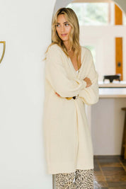Model Tegan wearing size S of the Adjourn To The Drawing Room Cardi in colour Buttermilk, from the front, showing the whole outfit
