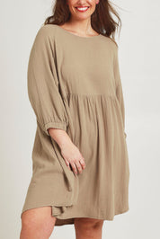 Model Jane wearing size 14 of the Feeling Free Cotton Smock Dress in colour Dust, from the front, cropped image