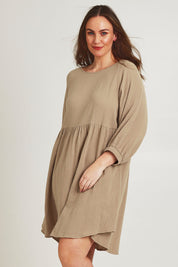 Model Jane wearing size 14 of the Feeling Free Cotton Smock Dress in colour Dust, from the front, cropped image