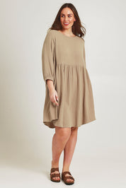Model Jane wearing size 14 of the Feeling Free Cotton Smock Dress in colour Dust, from the front, showing the whole outfit