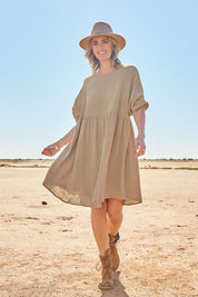 Model Tegan wearing size 10 of the Feeling Free Cotton Smock Dress in colour Dust, from the front, showing the whole outfit