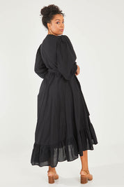 Model Noli wearing size 14 of the La Dolce Vita Long Sleeve Cotton Maxi Dress in colour Black (Black), from the back