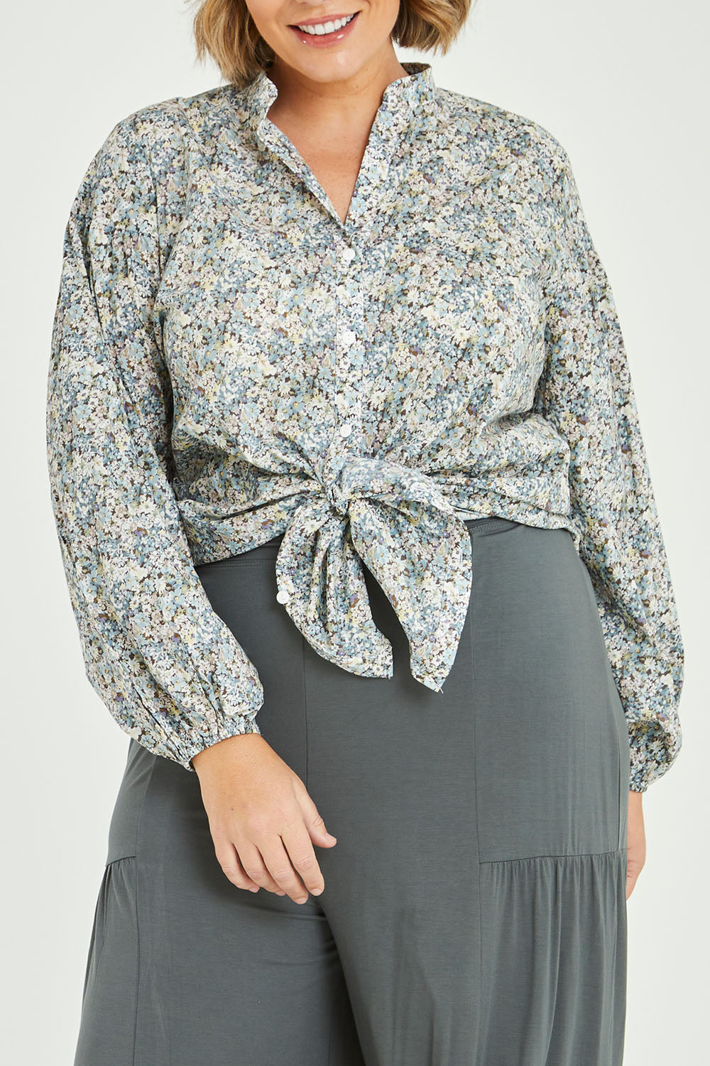 Model Fiona wearing size 16 of the You And Me Cotton Floral Blouse in colour Skyfleur (Blue), from the front, cropped image