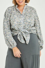 Model Fiona wearing size 16 of the You And Me Cotton Floral Blouse in colour Skyfleur (Blue), from the front, cropped image