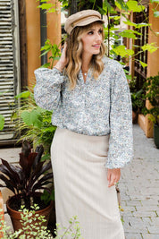 Model Tegan wearing size 10 of the You And Me Cotton Floral Blouse in colour Skyfleur (Blue), from the front, showing the whole outfit
