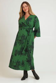 Model Chanel wearing size 16 of the Wrap Me Up In Cotton Maxi Dress in colour Emerald (Green), from the front, showing the whole outfit