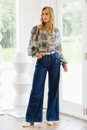 Model Tegan wearing size 10 of the Not A Patch On You Blouse in colour Tealpatch (Blue), from the front, showing the whole outfit