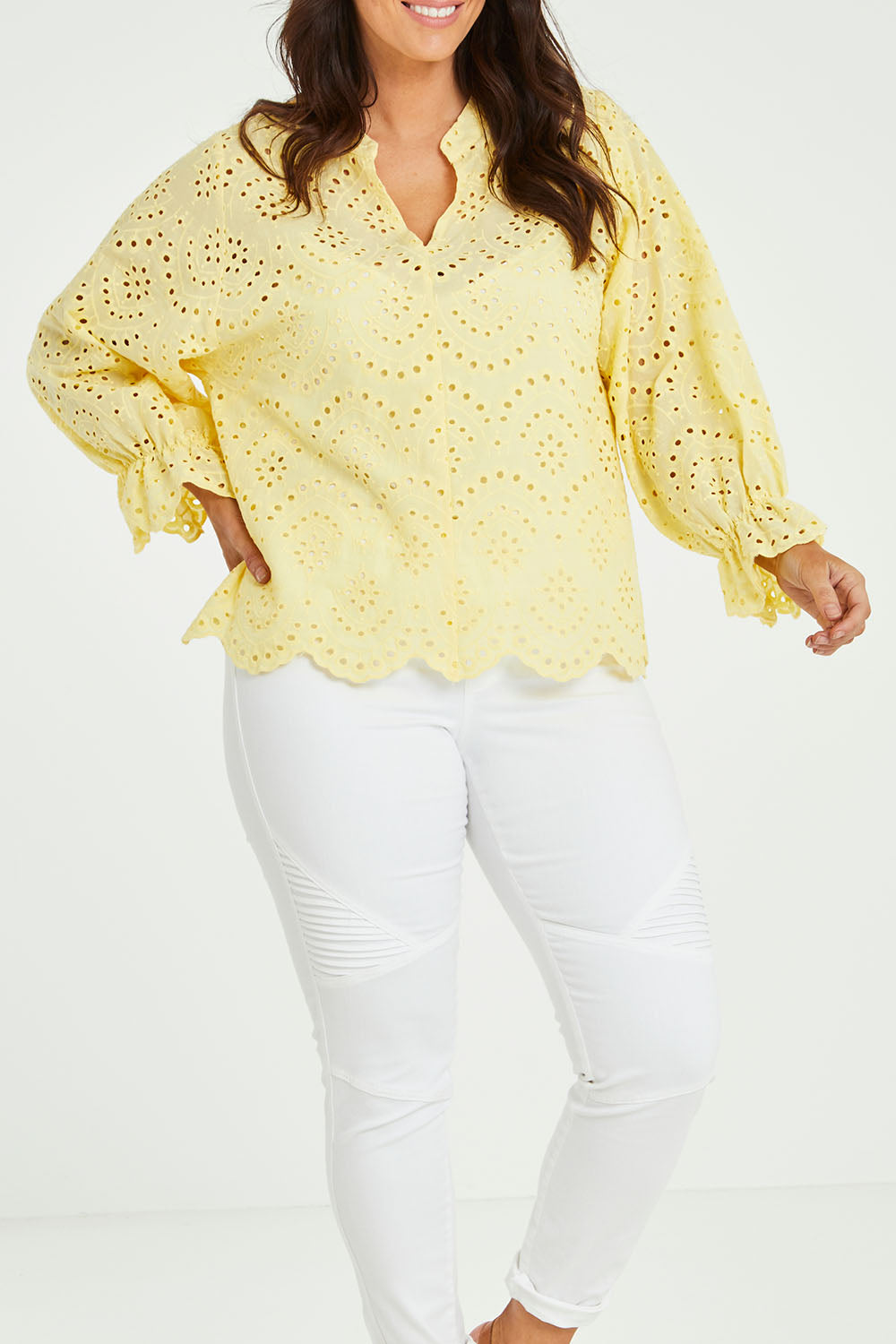 Model Laura wearing size 14 of the Sweet Pea Broderie Blouse in colour Sun, from the front, cropped image