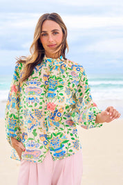Model Tegan wearing size 10 of the High Tea Garden Party Blouse in colour Garden, from the front, showing the whole outfit