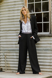 Model Tegan wearing size 10 of the All For Love Pants in colour Black (Black), from the front, showing the whole outfit
