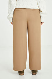 Model Laura wearing size 14 of the All For Love Pants in colour Camel, from the back