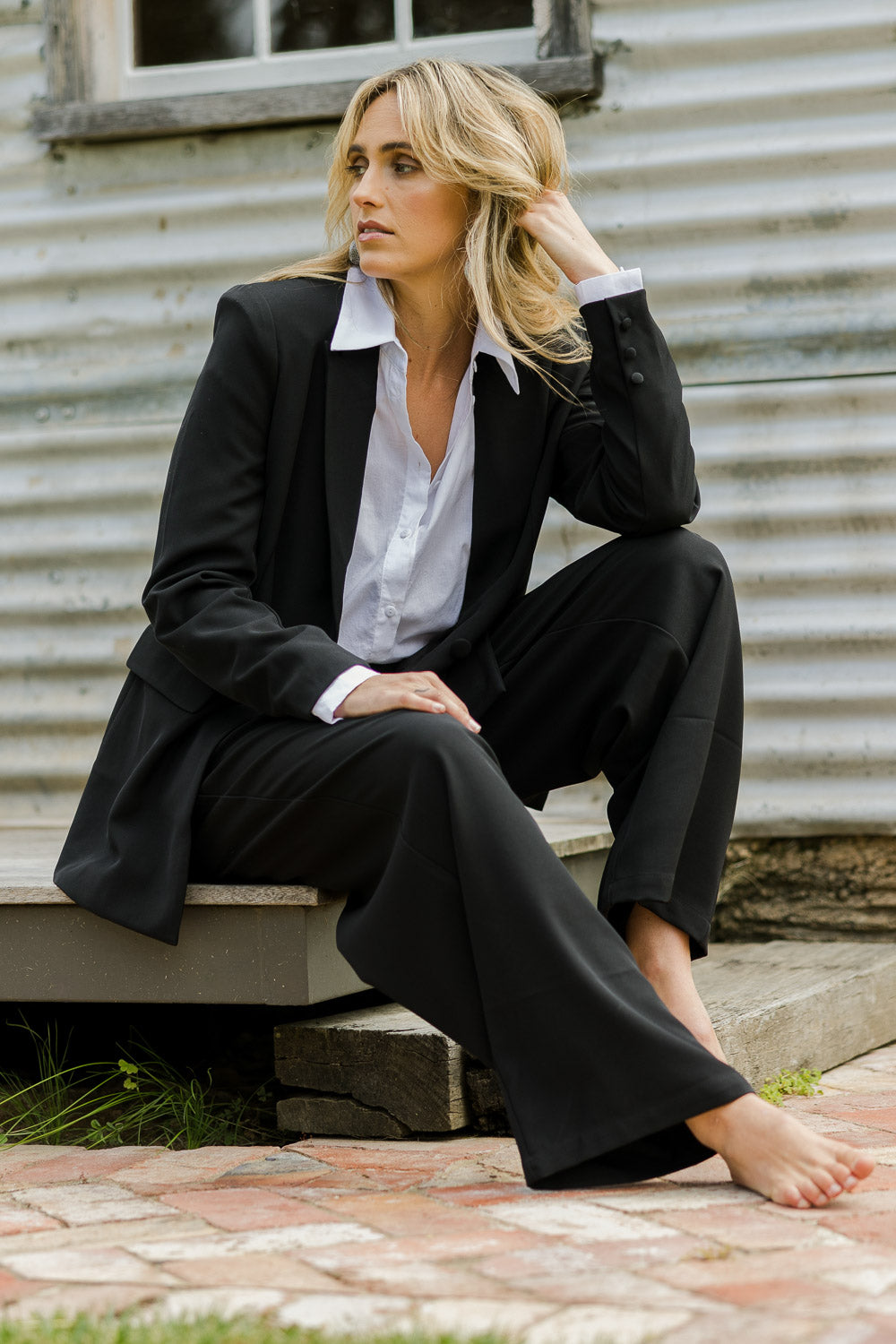 Model Tegan wearing size 10 of the All For Love Blazer in colour Black (Black), from the front, showing the whole outfit