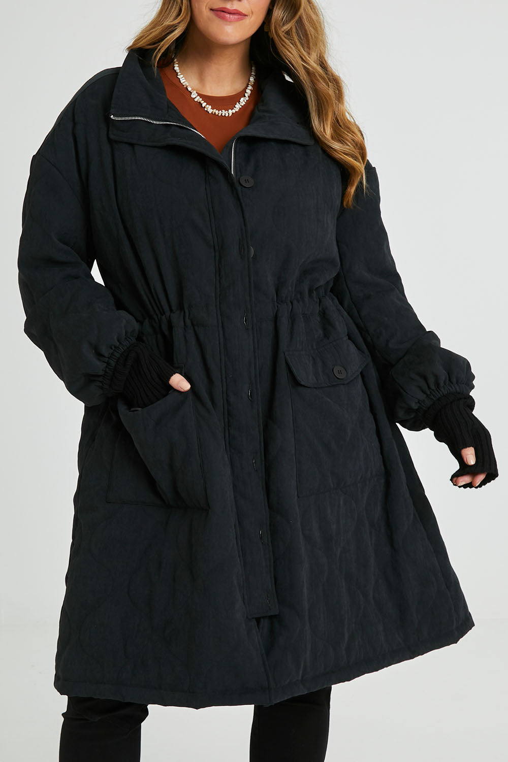 Model Laura wearing size 14 of the Heart Warming Quilted Anorak in colour Black (Black), from the front, cropped image