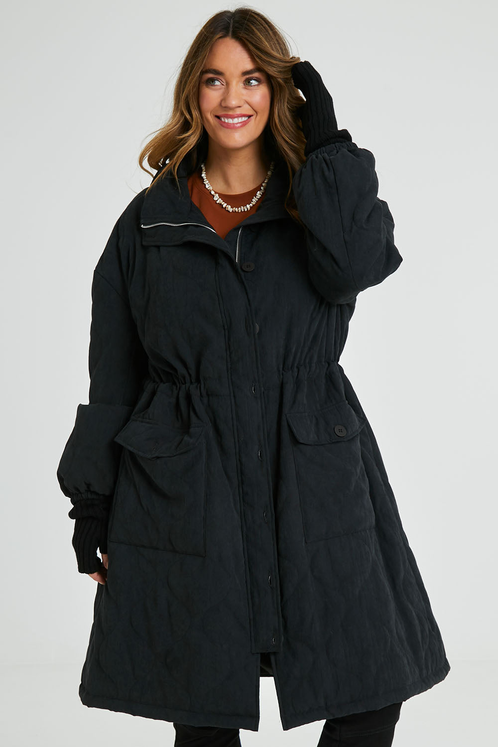 Model Laura wearing size 14 of the Heart Warming Quilted Anorak in colour Black (Black), from the front, cropped image