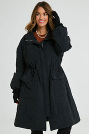 Model Laura wearing size 14 of the Heart Warming Quilted Anorak in colour Black (Black), from the front, cropped image