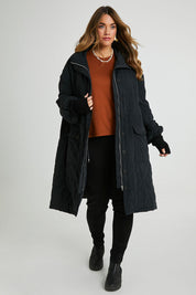 Model Laura wearing size 14 of the Heart Warming Quilted Anorak in colour Black (Black), from the front, showing the whole outfit