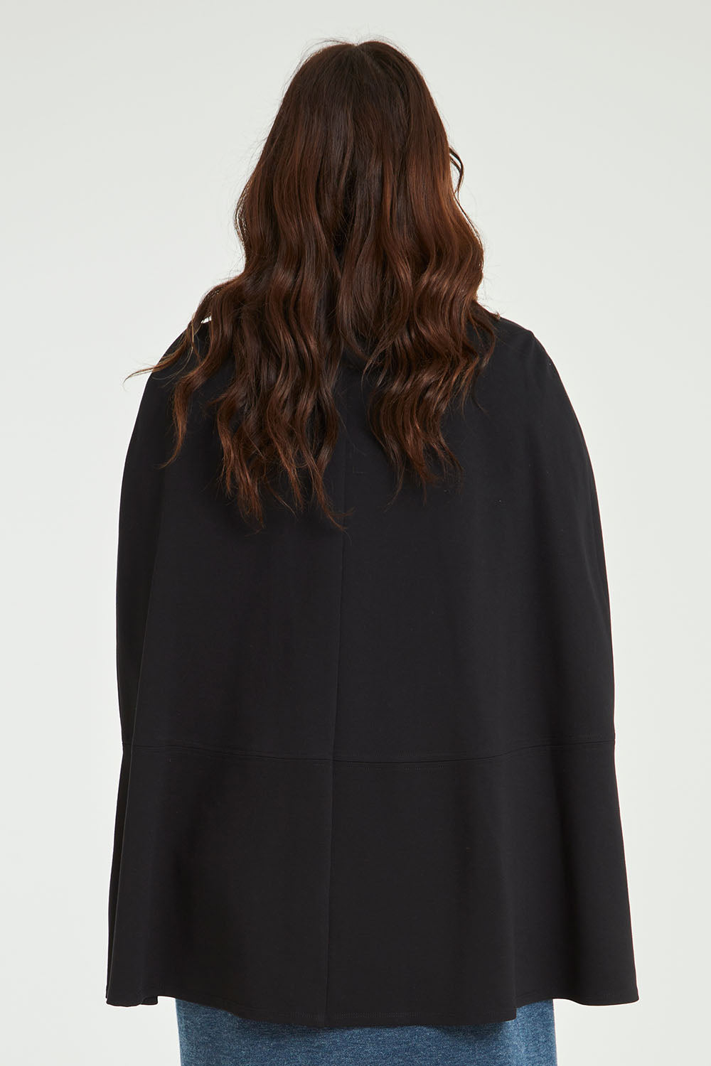 Model Laura wearing size 14 of the Sherlock And I Ponte Cape in colour Black (Black), from the back