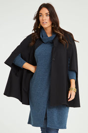Model Laura wearing size 14 of the Sherlock And I Ponte Cape in colour Black (Black), from the front, cropped image